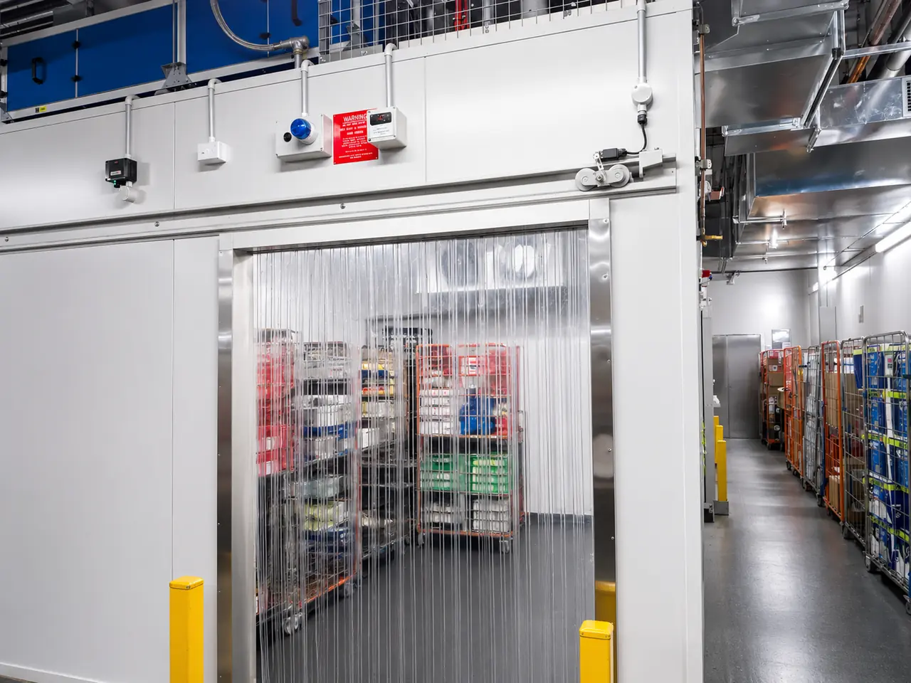 Strip curtain door at a cold storage entry in an operating facility